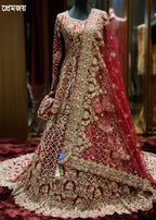 Elaborately embroidered red and gold traditional outfit on a mannequin.
