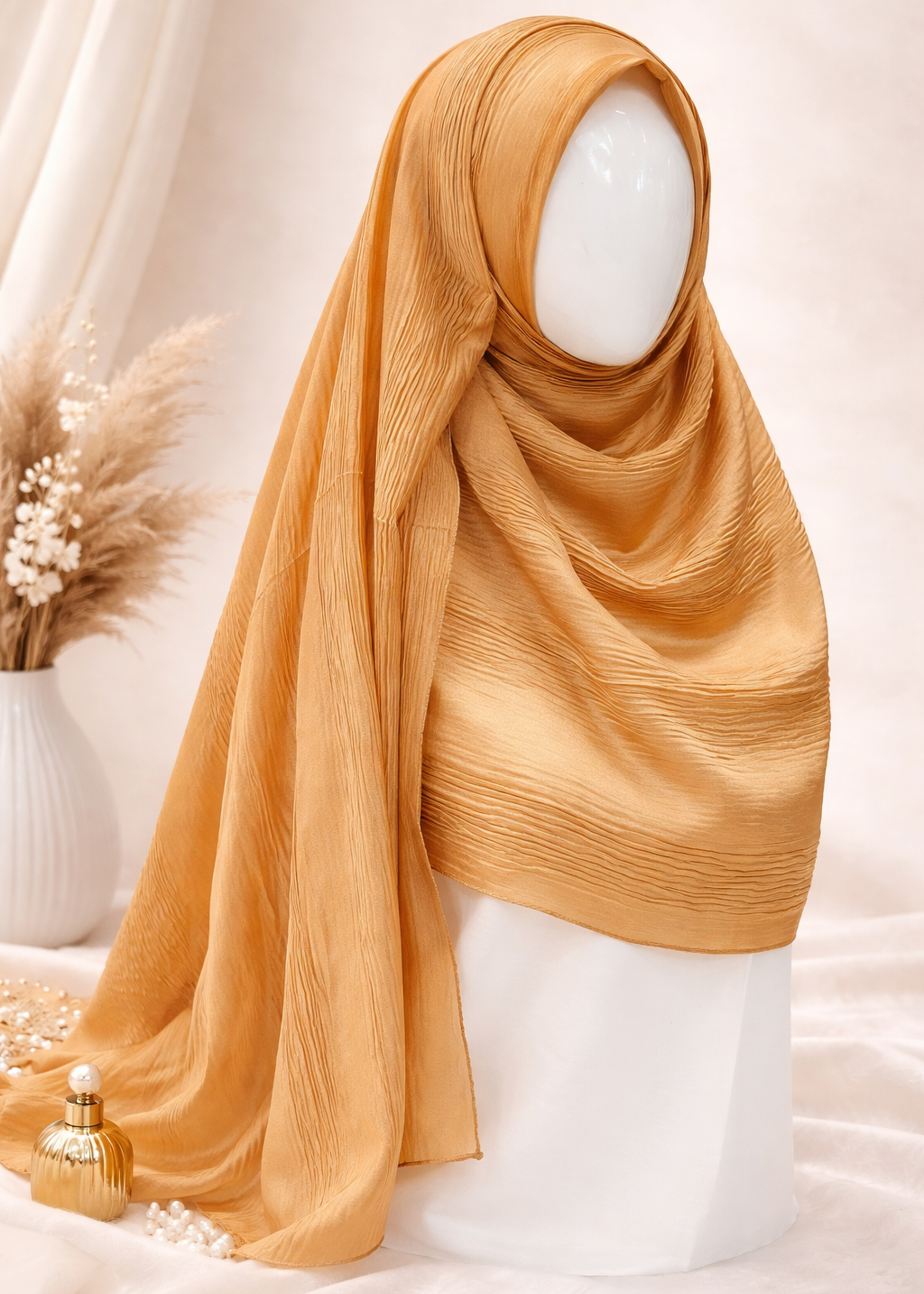Gold hijab on a mannequin head with a neutral background