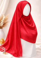 Red hijab on a mannequin head against a neutral background