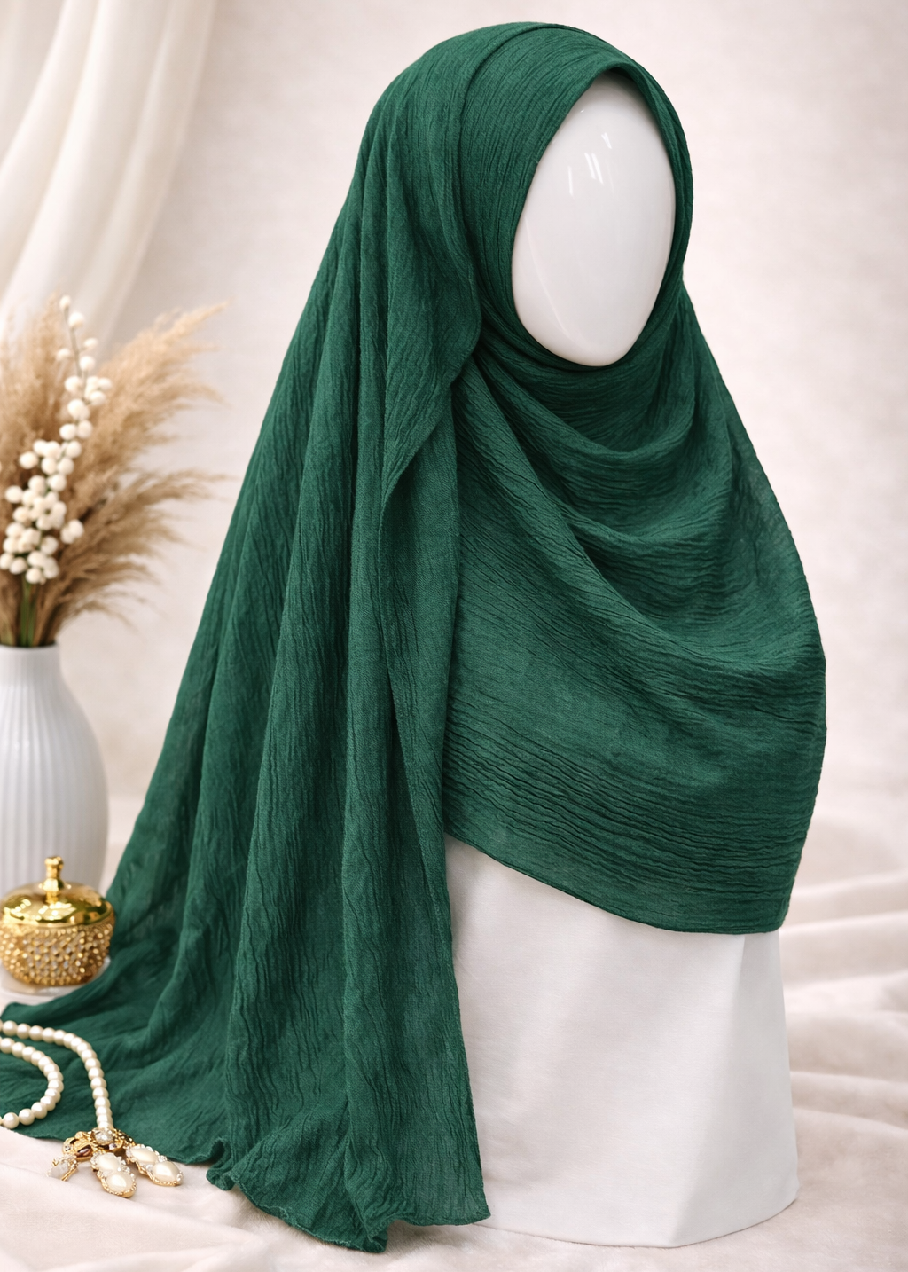 Green hijab on a mannequin head with a neutral background