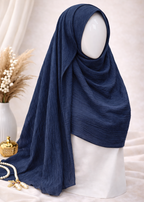 Navy blue hijab on a mannequin head with a neutral background