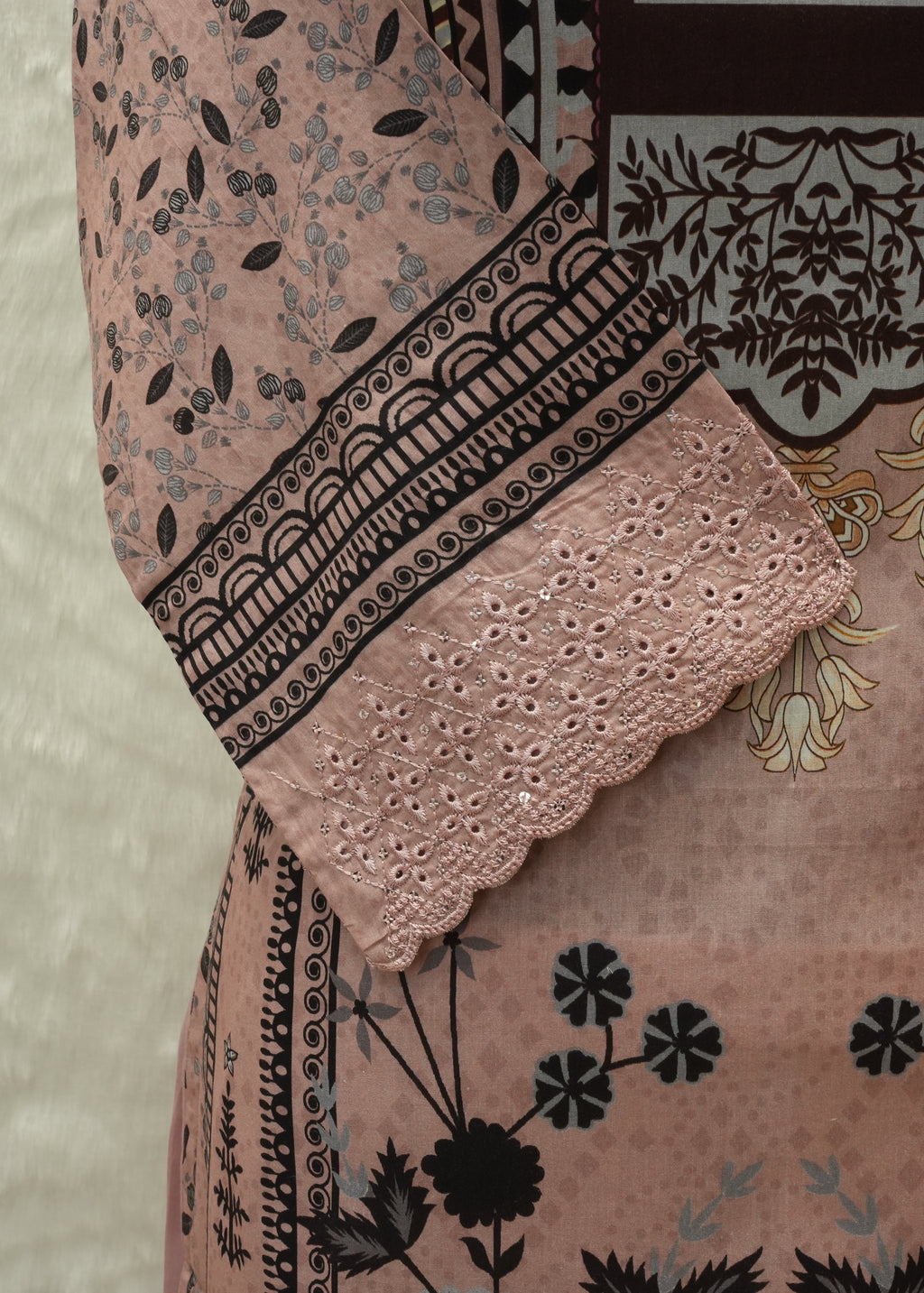 Close-up of a patterned fabric with floral and geometric designs.