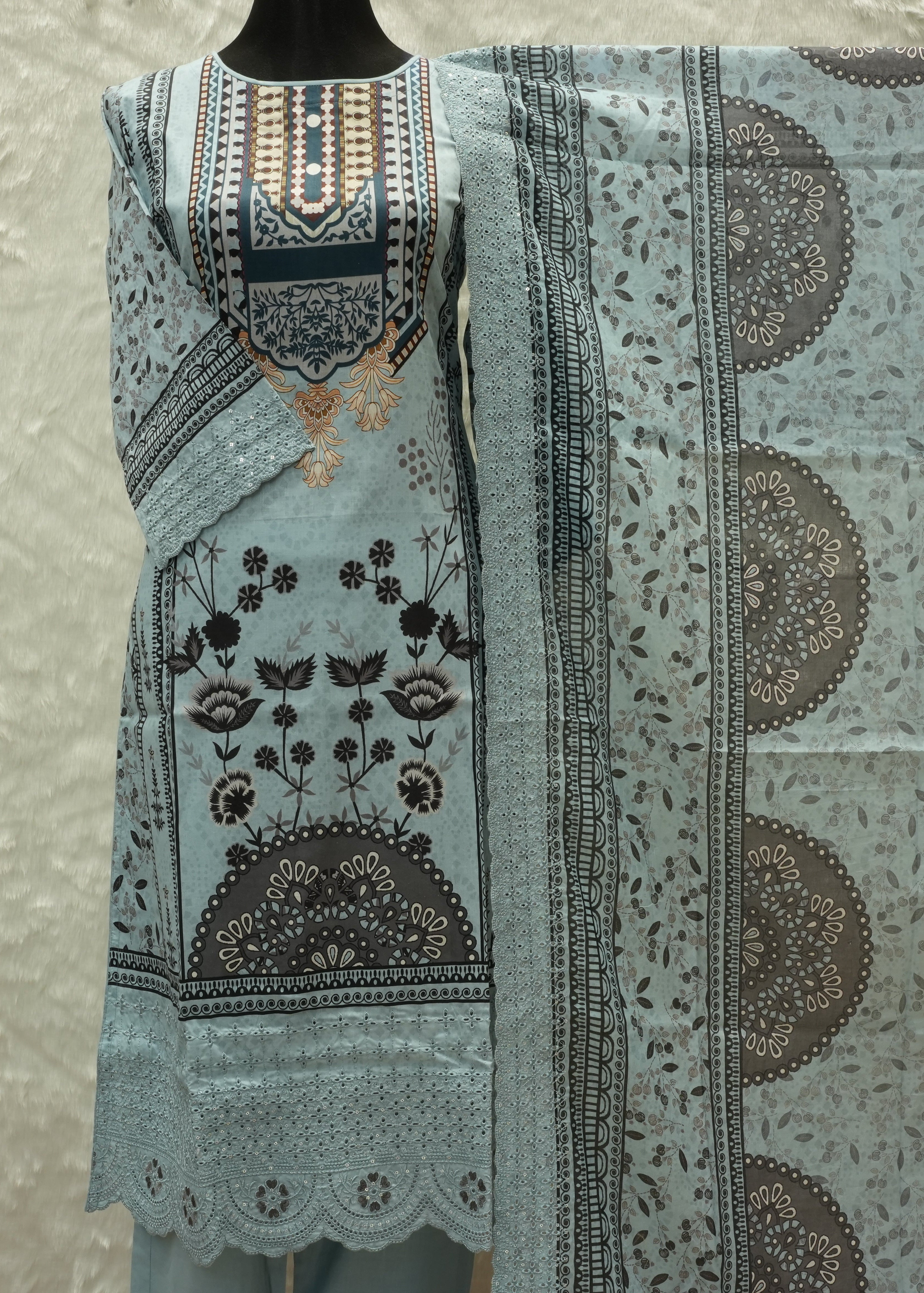 Light blue fabric with intricate patterns on a neutral background