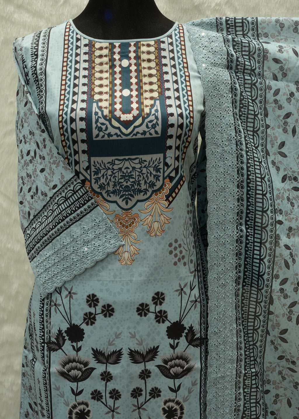 Embroidered fabric with intricate patterns on a neutral background