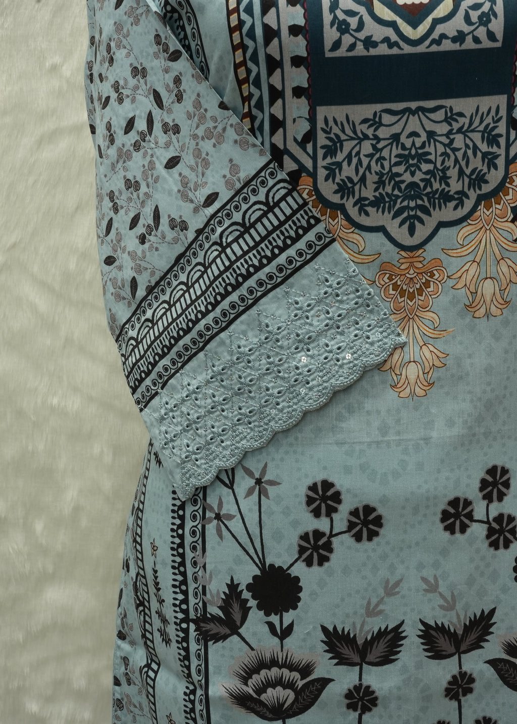 Close-up of a patterned fabric with floral and geometric designs on a textured background
