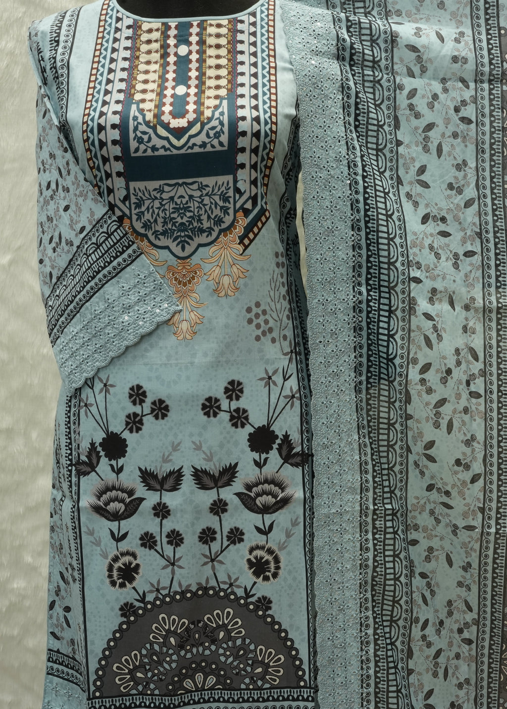 Folded fabric with intricate patterns on a neutral background