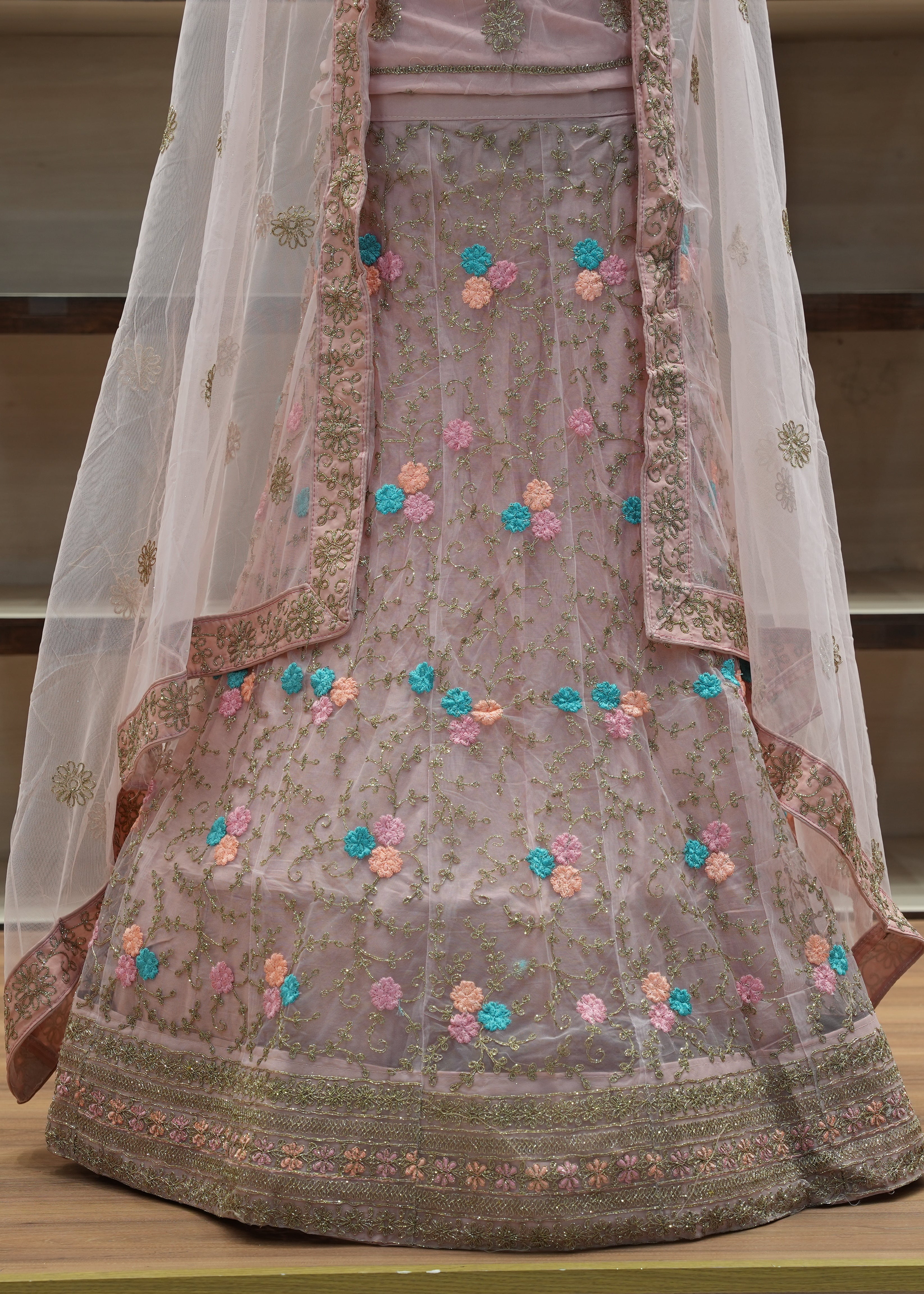 Traditional embroidered outfit with floral patterns on a wooden surface