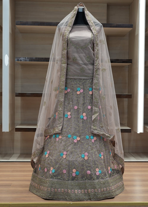 Traditional outfit with floral embroidery on a mannequin against a neutral background
