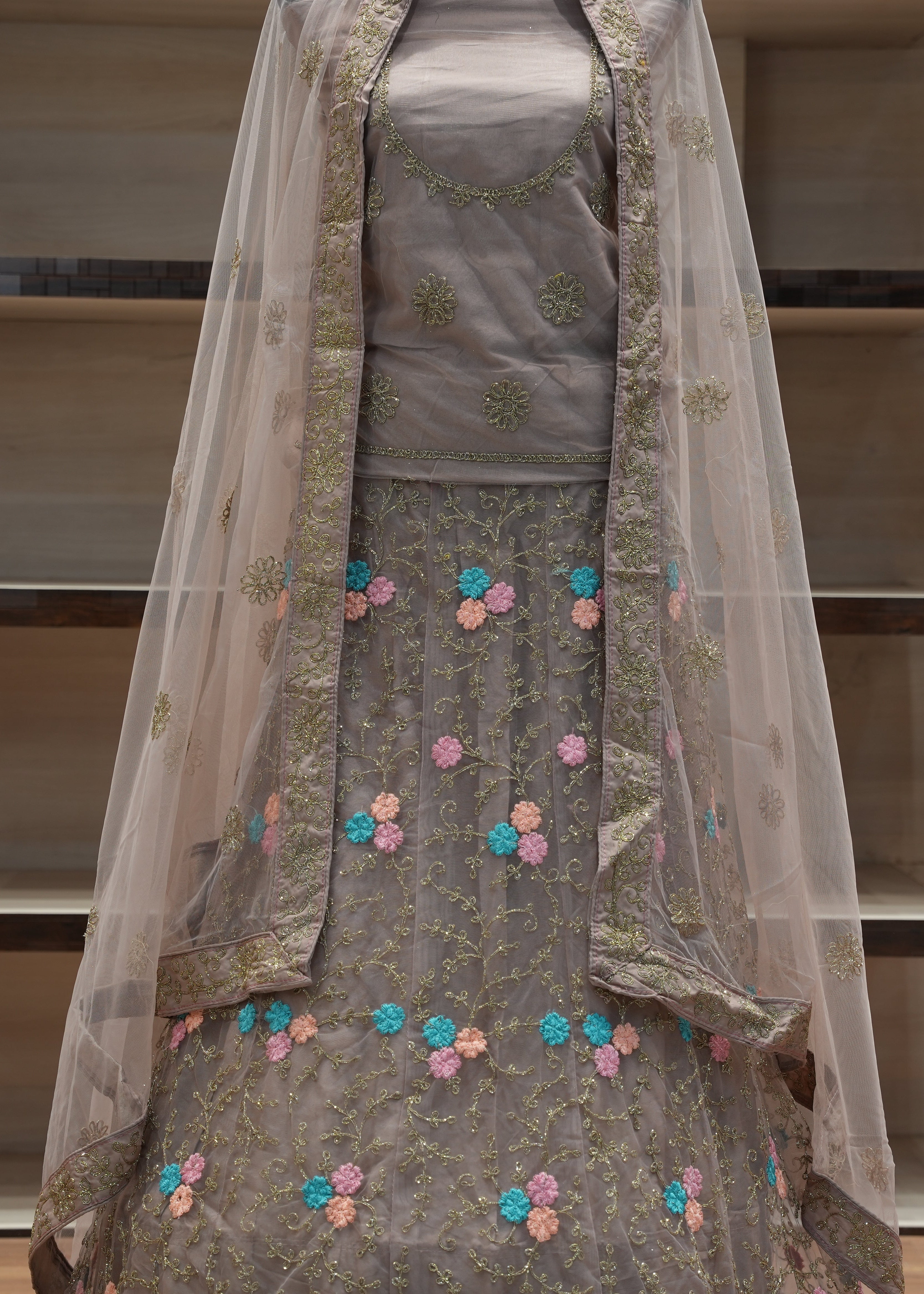 Traditional outfit with floral embroidery on a neutral background