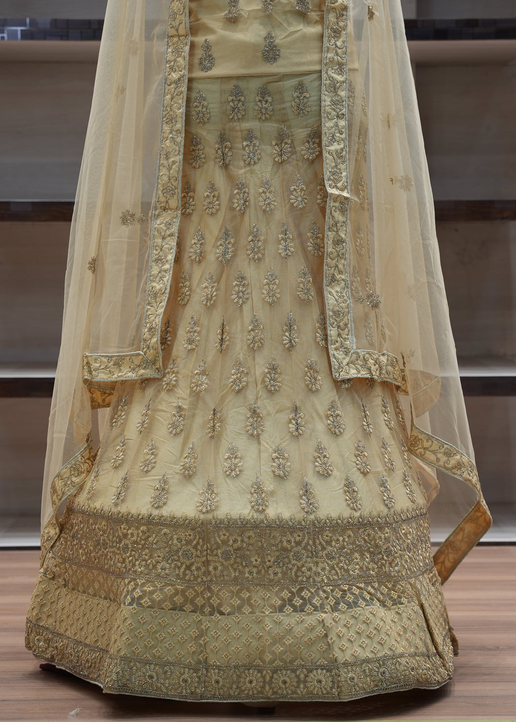 Decorative traditional outfit with intricate patterns on a wooden floor.