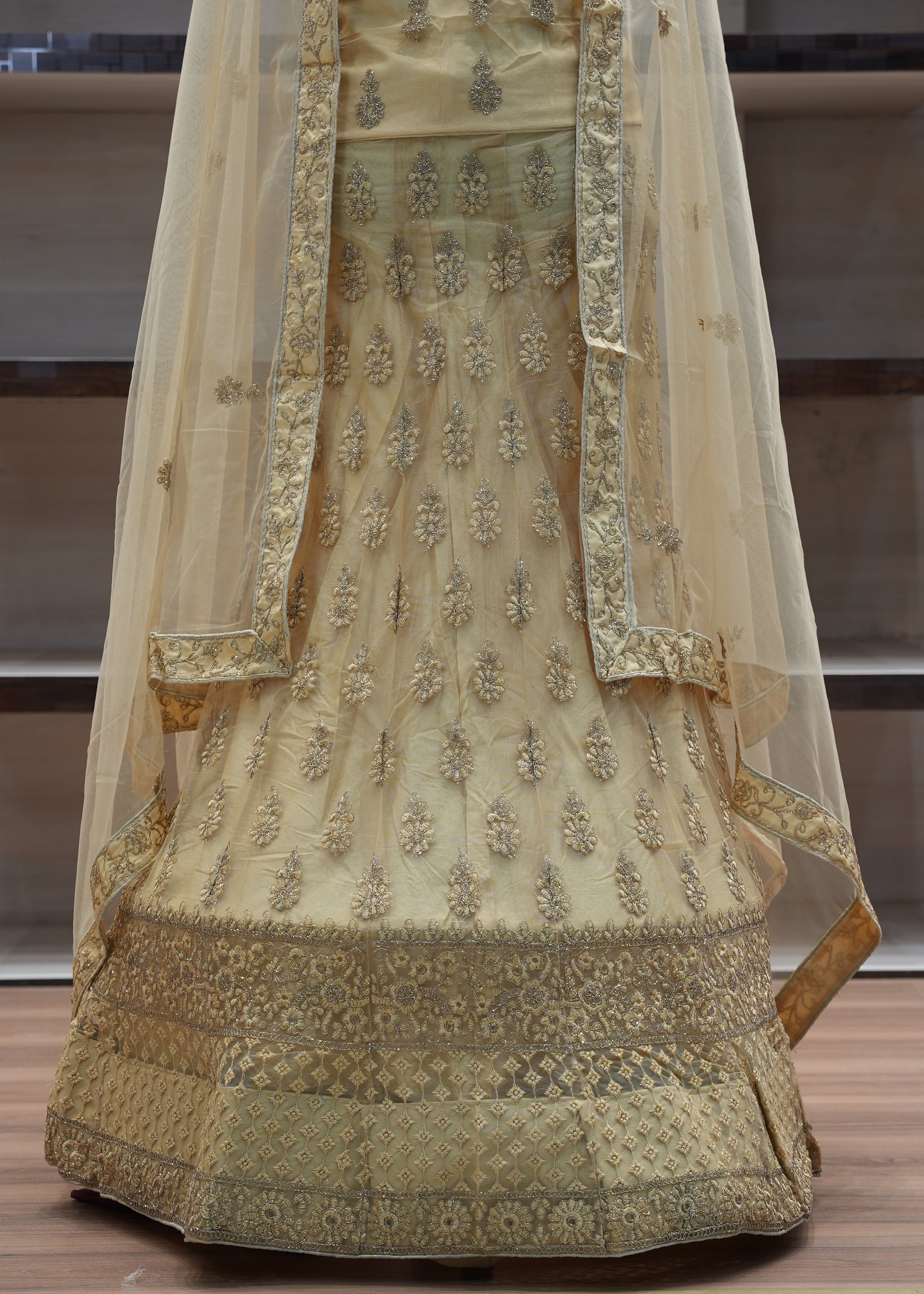 Decorative traditional outfit with intricate patterns on a wooden floor.