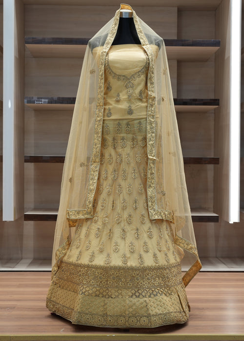 Traditional embroidered dress with a dupatta on a mannequin against a neutral background