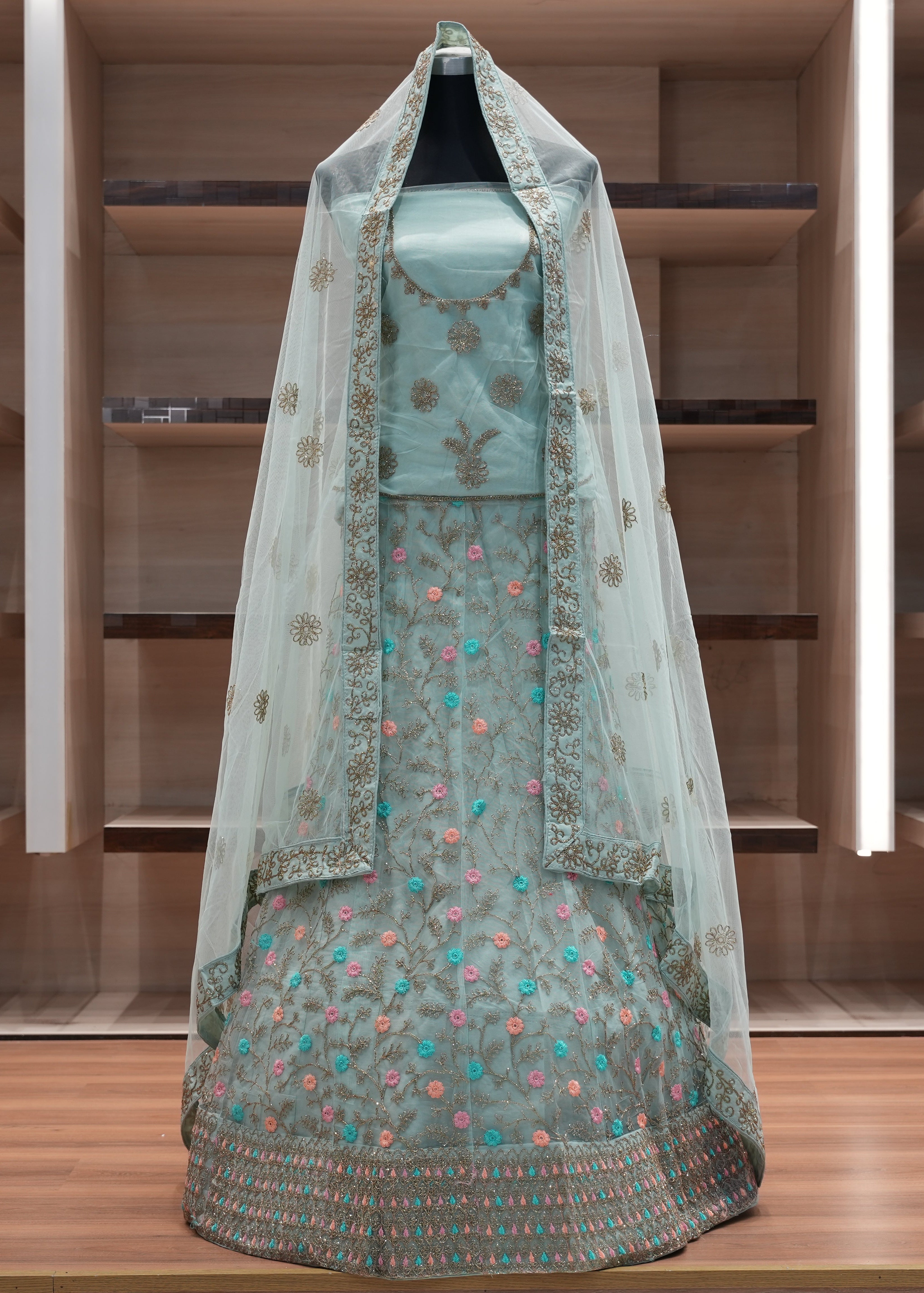 Traditional embroidered dress with a veil on a wooden shelf