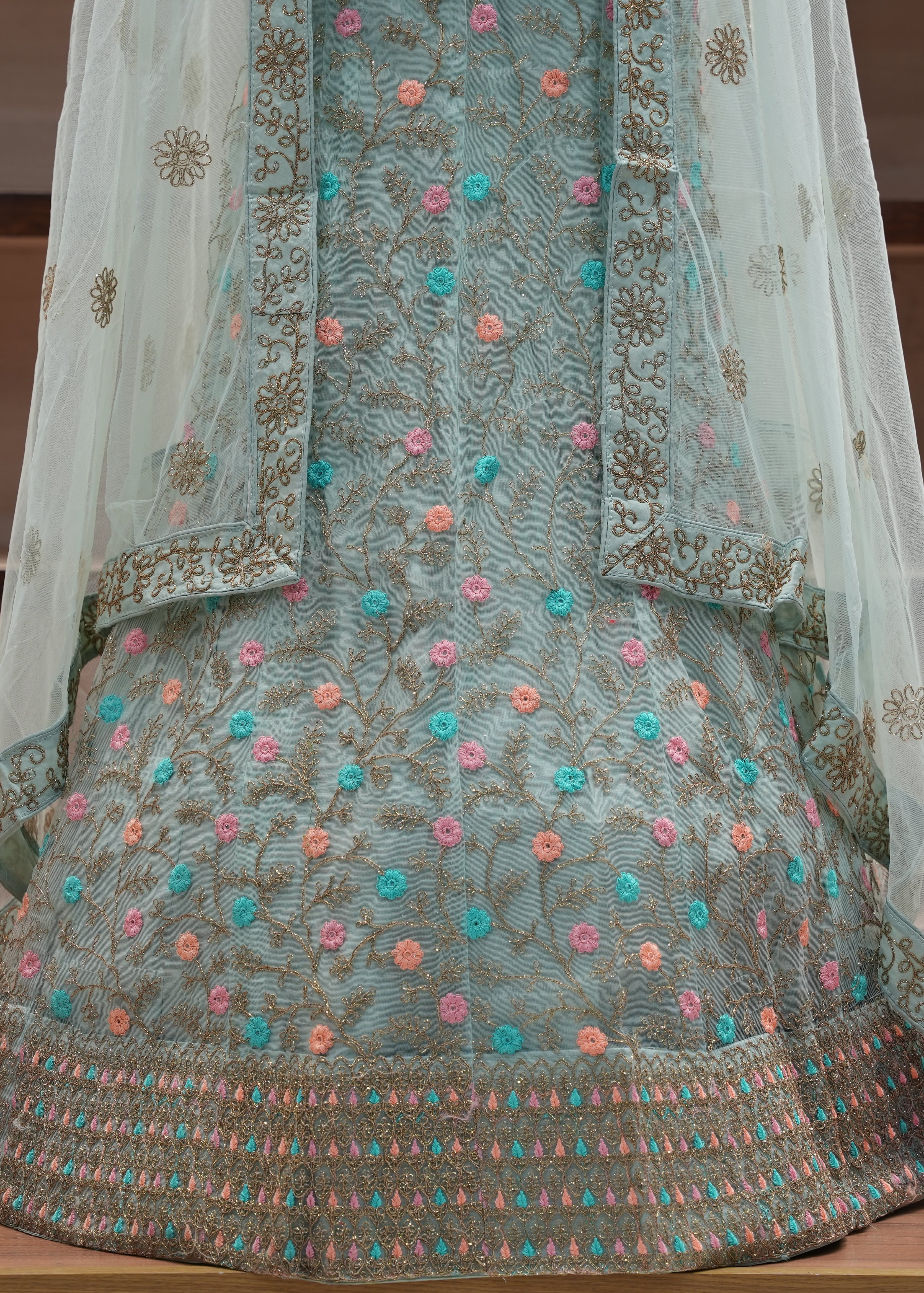 Embroidered traditional outfit with floral patterns on a wooden surface