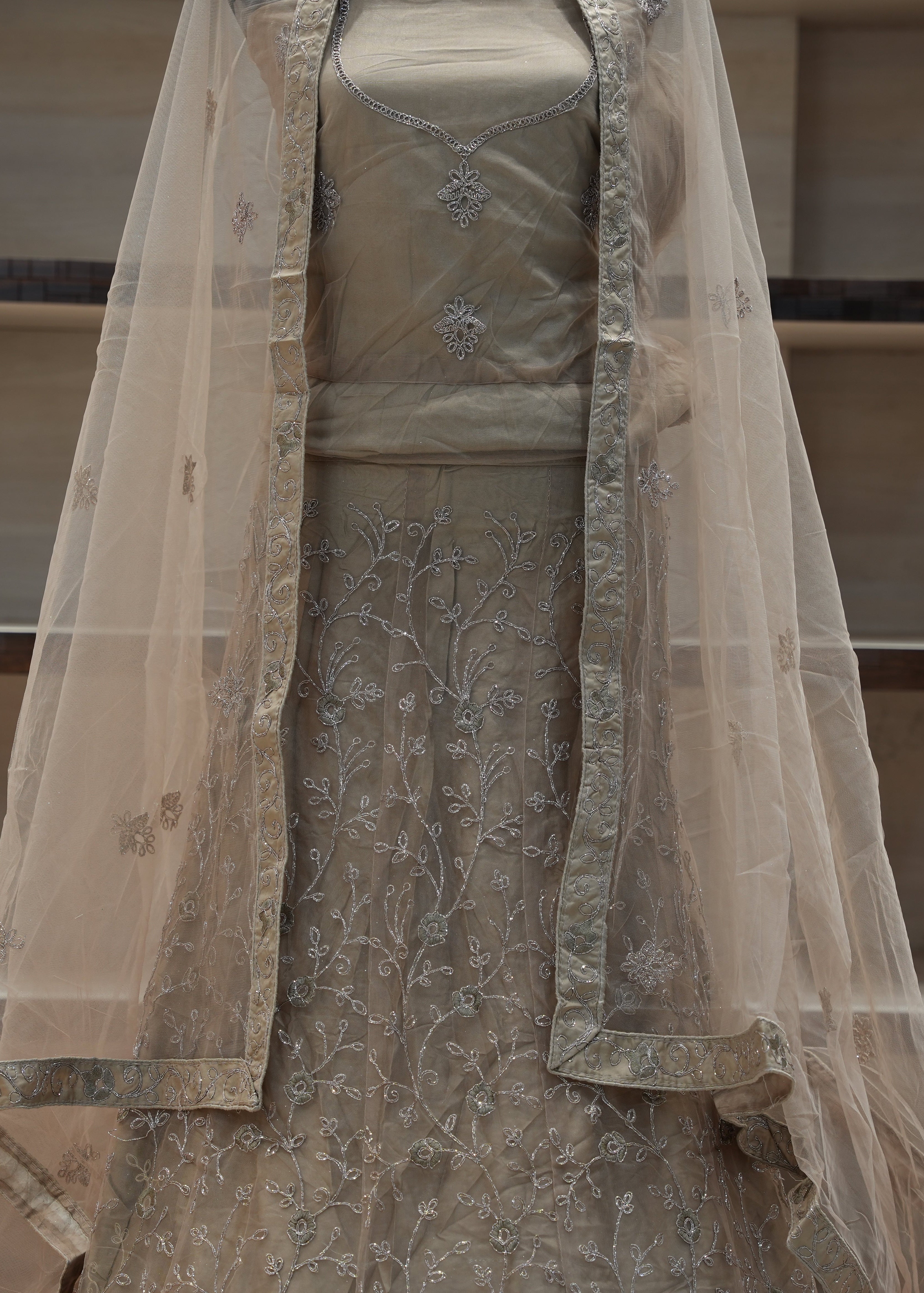 Beige embroidered dress with a sheer dupatta on a neutral background