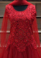 Red embroidered dress with a sheer overlay on a neutral background