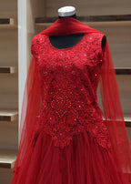Red lace dress on a mannequin against a neutral background