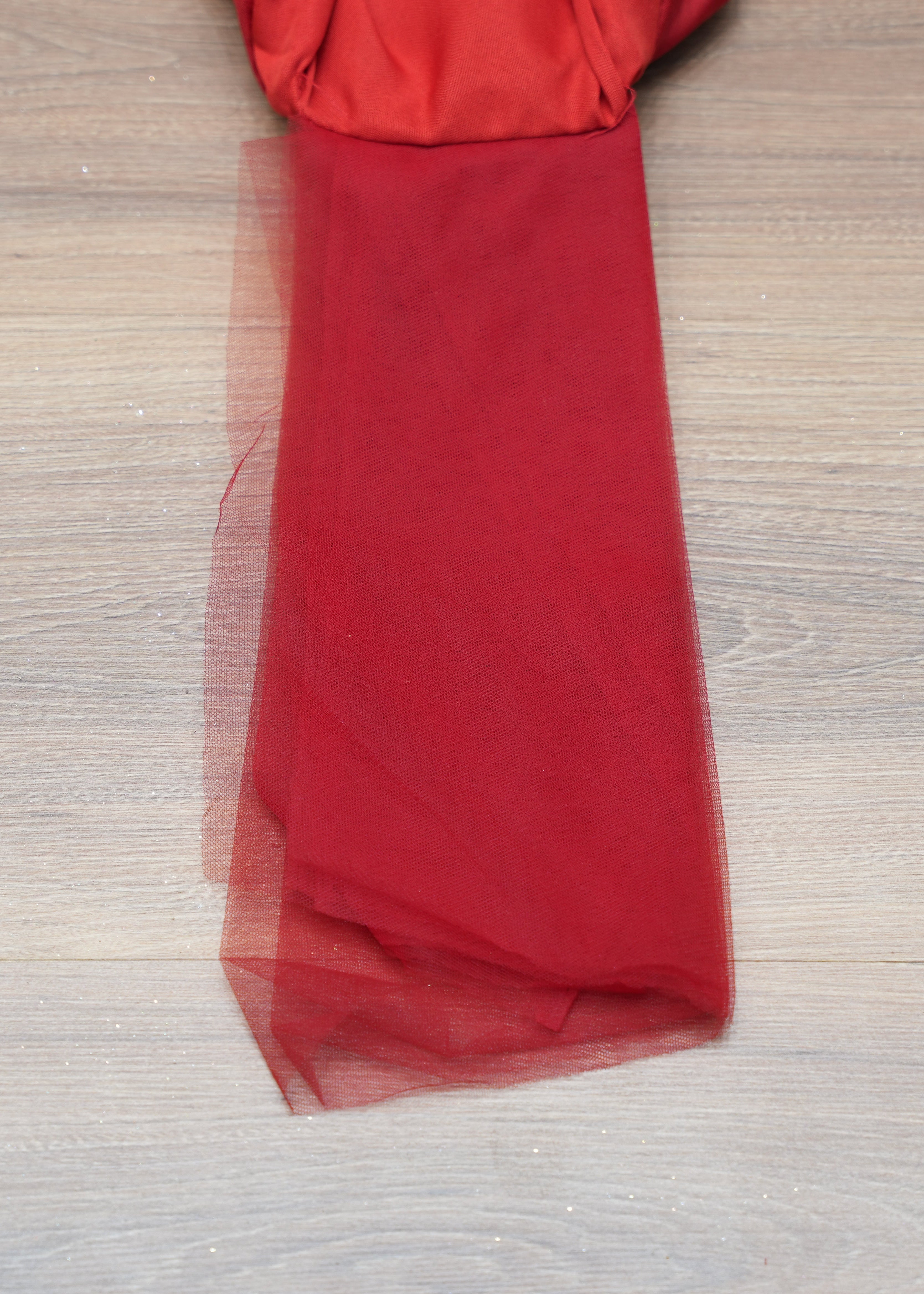 Red fabric on a wooden surface