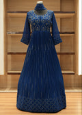Blue pleated dress with floral patterns on a wooden shelf