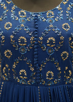Close-up of a blue dress with intricate gold embroidery