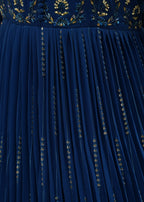 Close-up of a blue dress with gold embroidery details