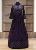 Purple dress with intricate detailing on a wooden shelf