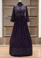 Purple dress with intricate detailing on a wooden shelf