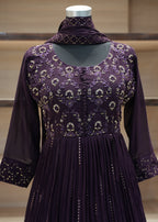 Purple dress with floral patterns on a mannequin against a neutral background