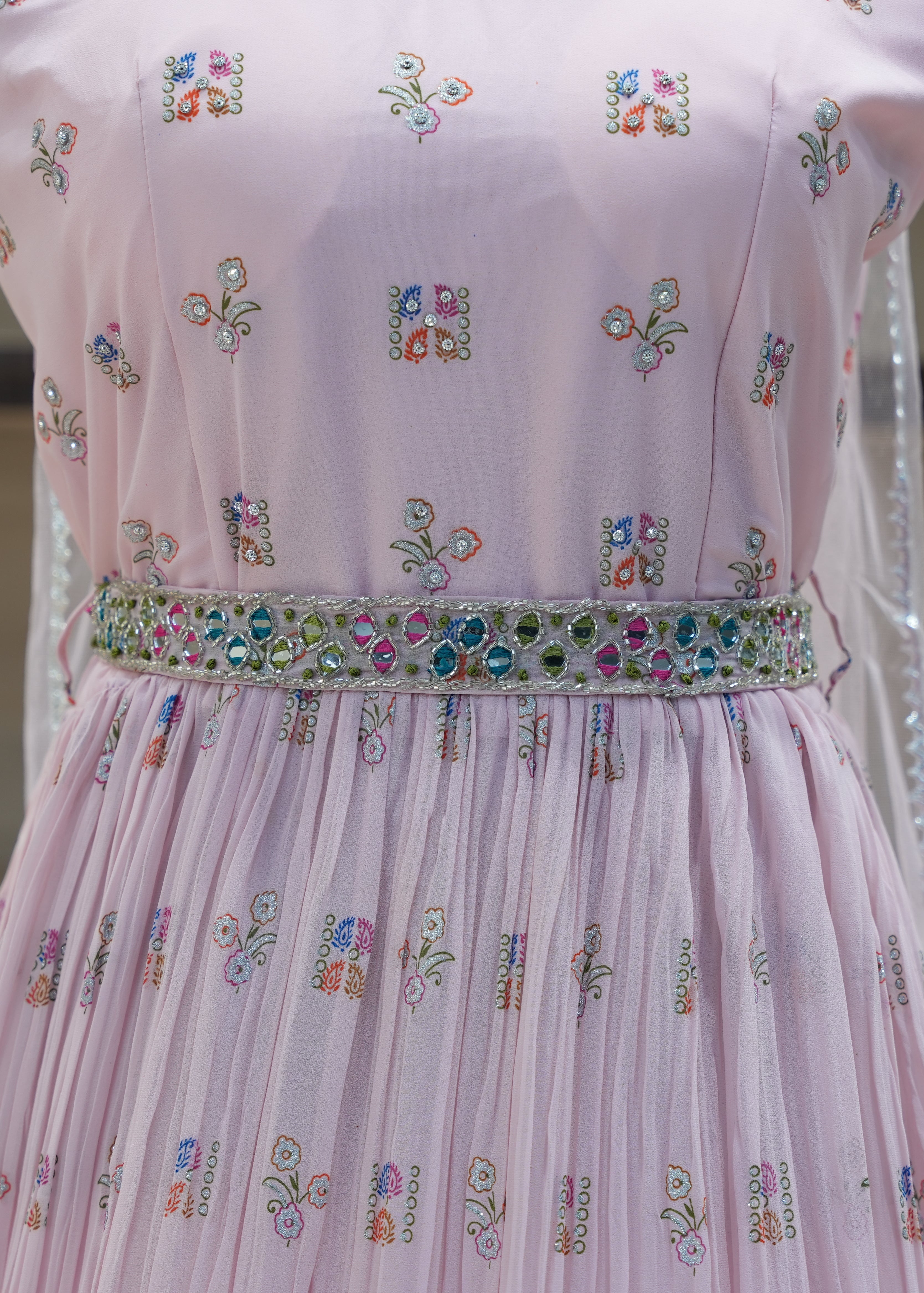 Pink embroidered dress with a blurred background