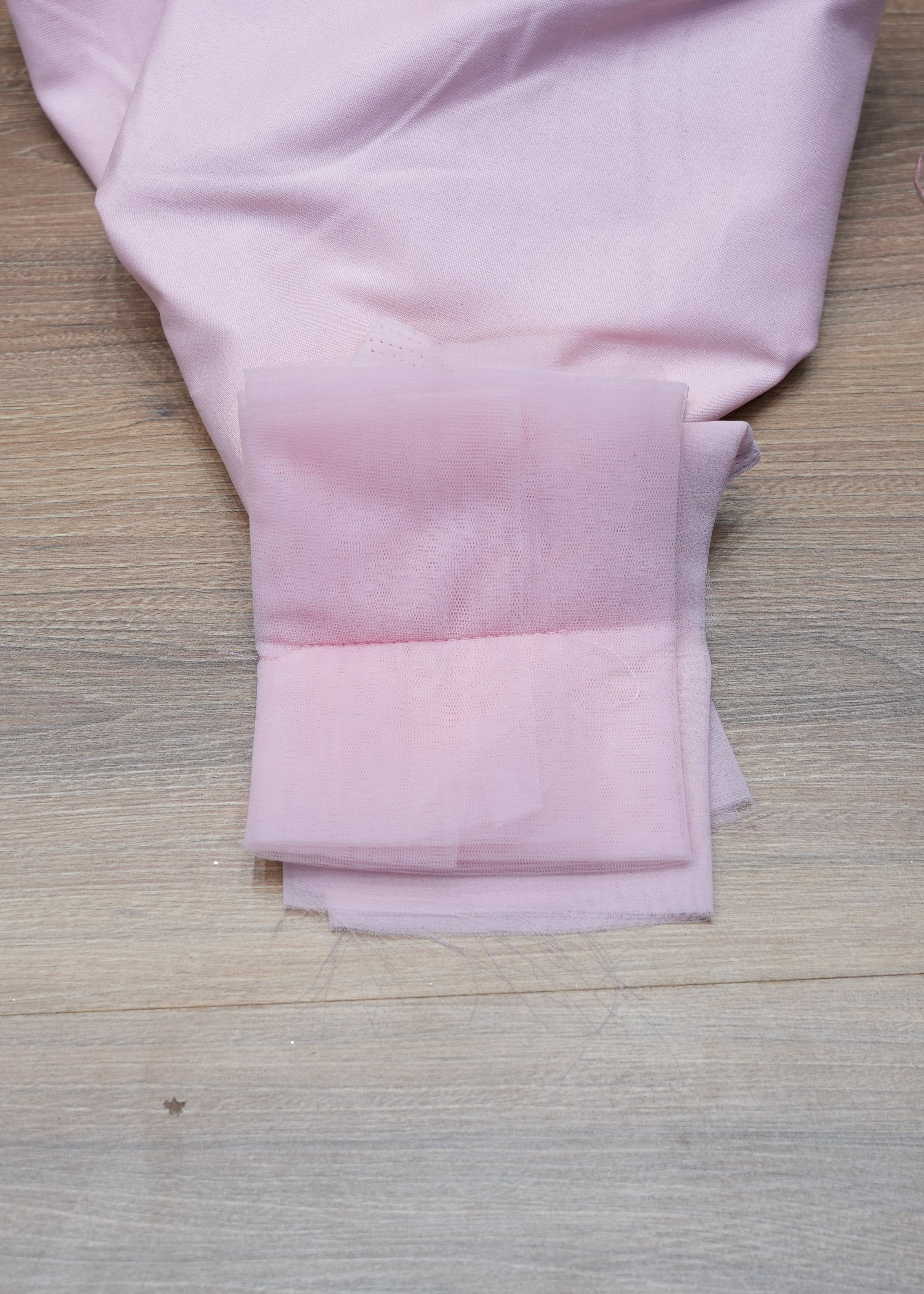 Pink fabric on a wooden surface