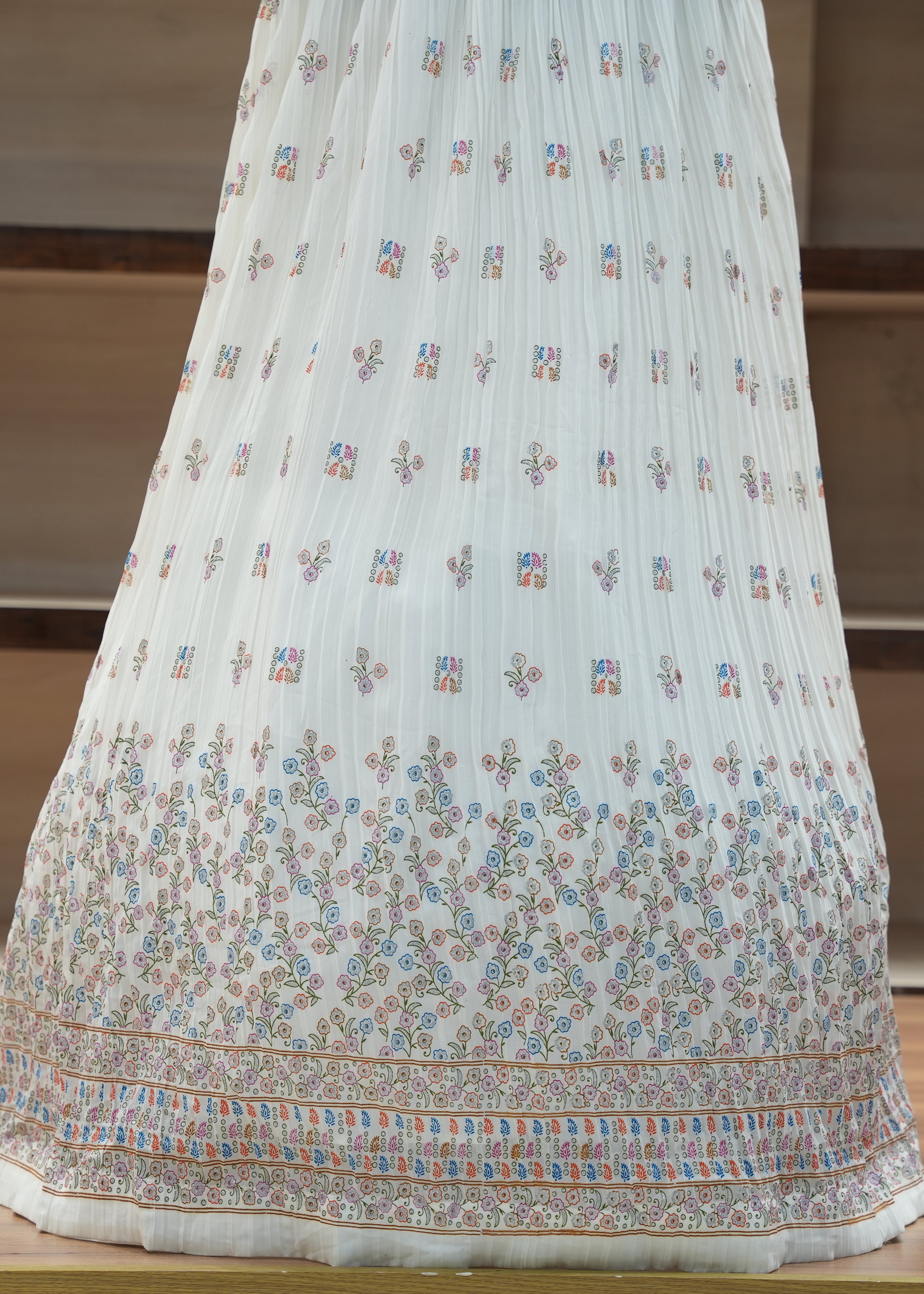 White embroidered fabric on a wooden surface with a neutral background