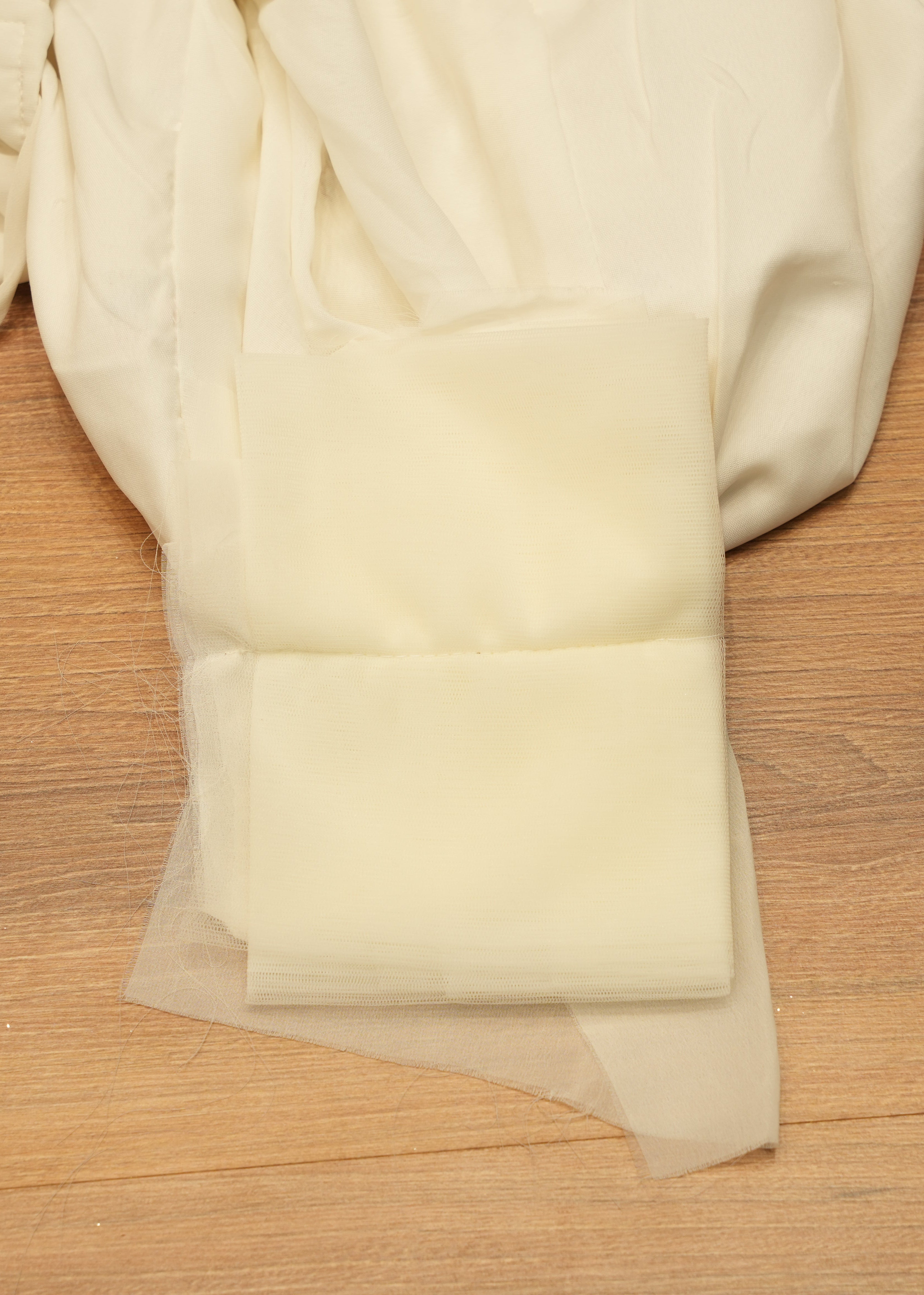 White fabric with floral embroidery on a wooden surface