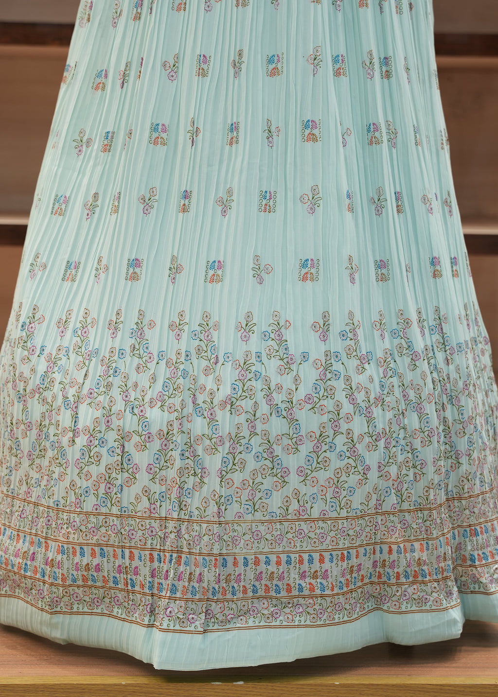 Light blue floral-patterned dress on a wooden surface