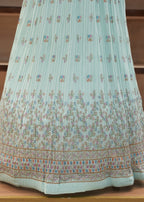 Light blue floral-patterned dress on a wooden surface