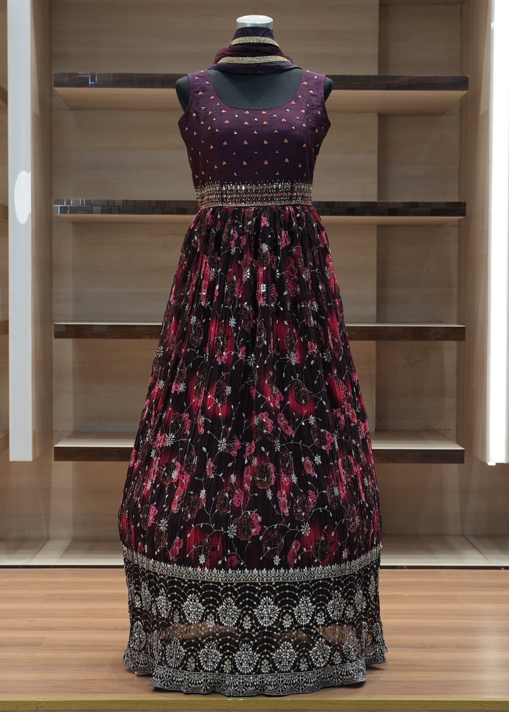 Patterned dress on a mannequin against a wooden panel background