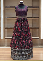 Mannequin wearing a patterned dress against a wooden panel background