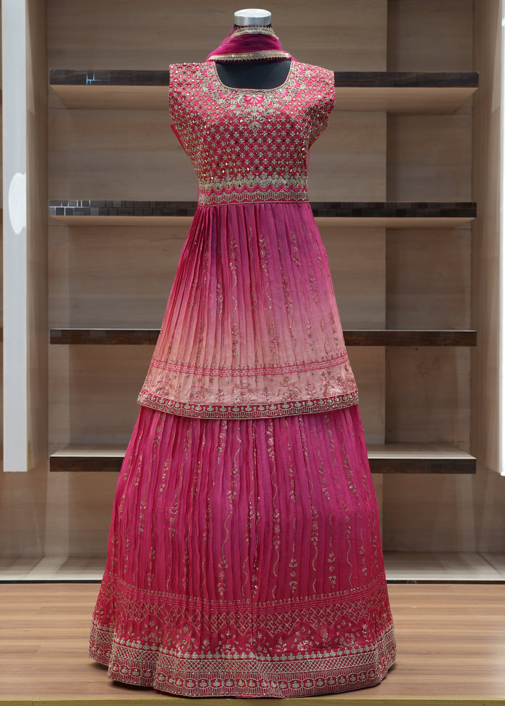 Red embroidered dress on a mannequin against a wooden panel background