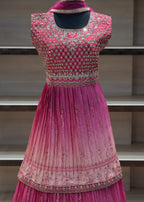 Pink embroidered dress on a mannequin against a neutral background
