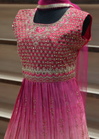 Pink embroidered garment against a neutral background