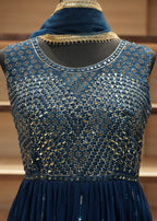 Blue embroidered garment on a mannequin against a neutral background