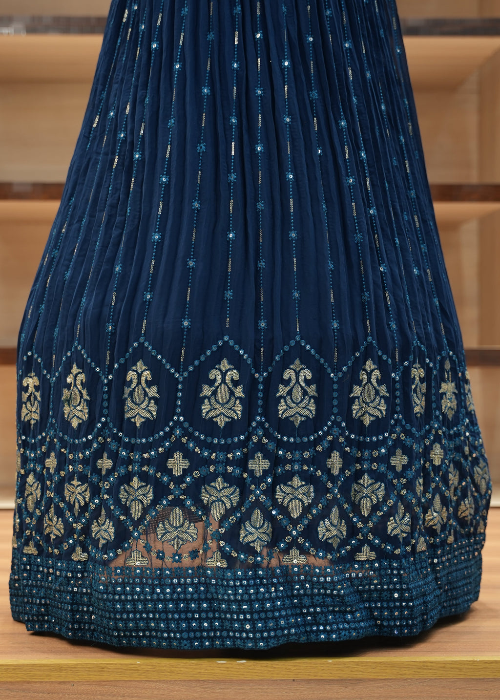 Blue embroidered fabric on a wooden surface