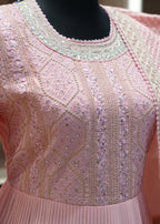 Close-up of a pink embroidered garment on a mannequin