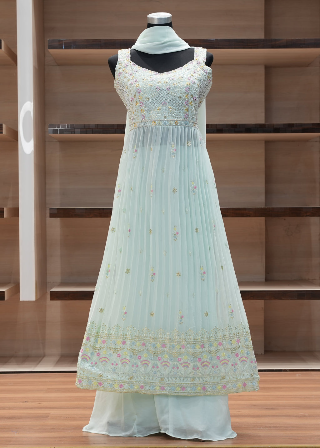 Light blue dress on a mannequin against a wooden background