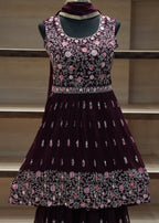 Decorative dress with floral patterns on a mannequin against a neutral background