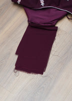 Purple fabric with white patterns on a wooden surface