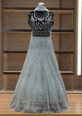 Silver evening gown with intricate detailing on a wooden shelf