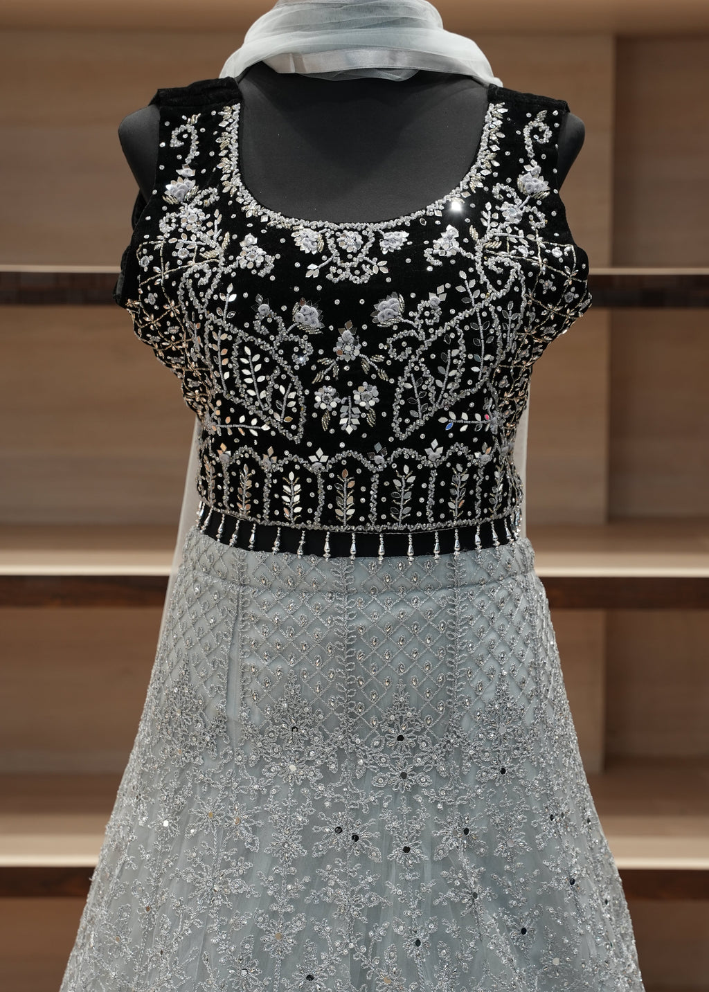 Gray sleeve with black and white beaded cuff against a wooden background