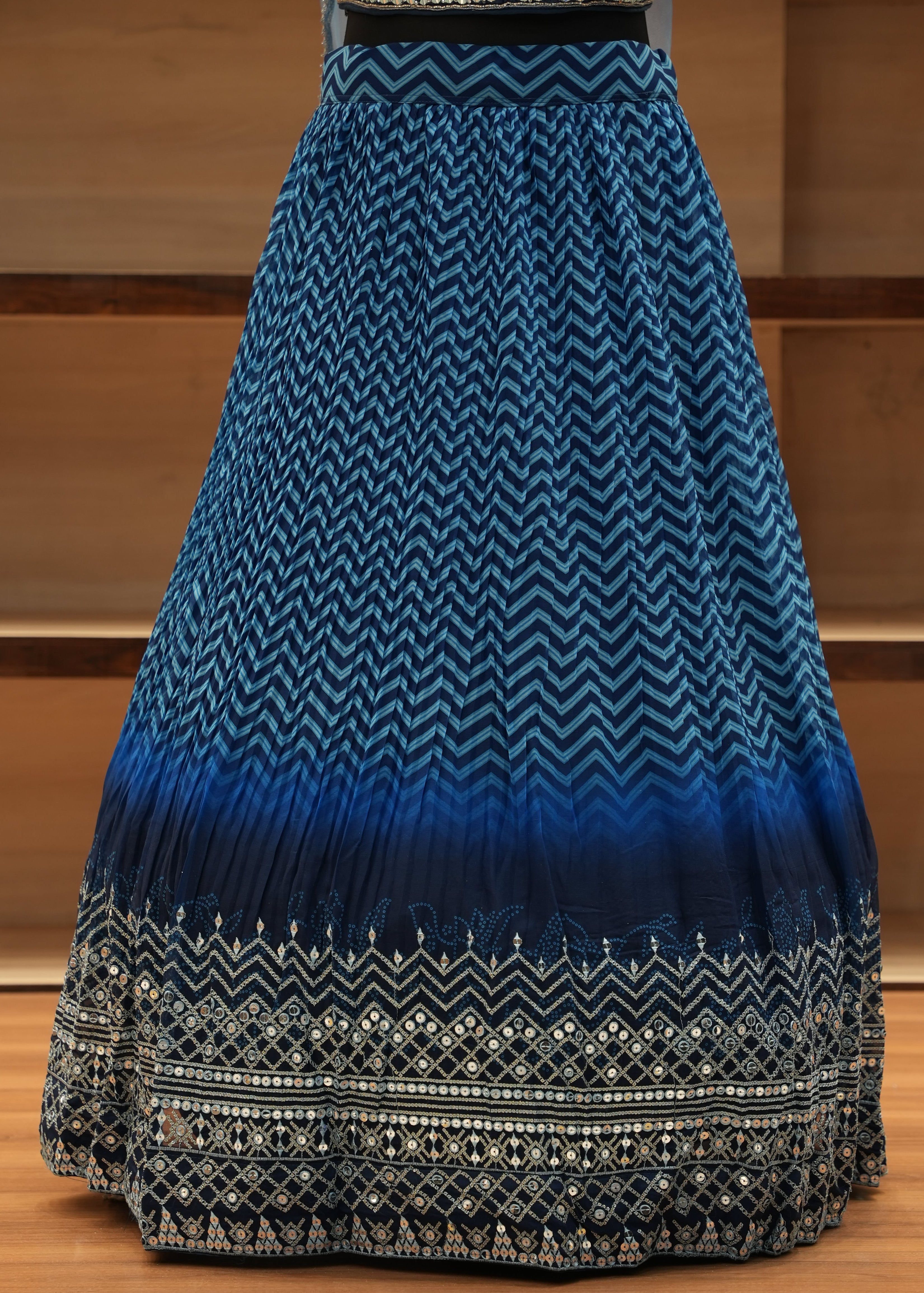 Blue and black patterned fabric draped over a wooden chair.