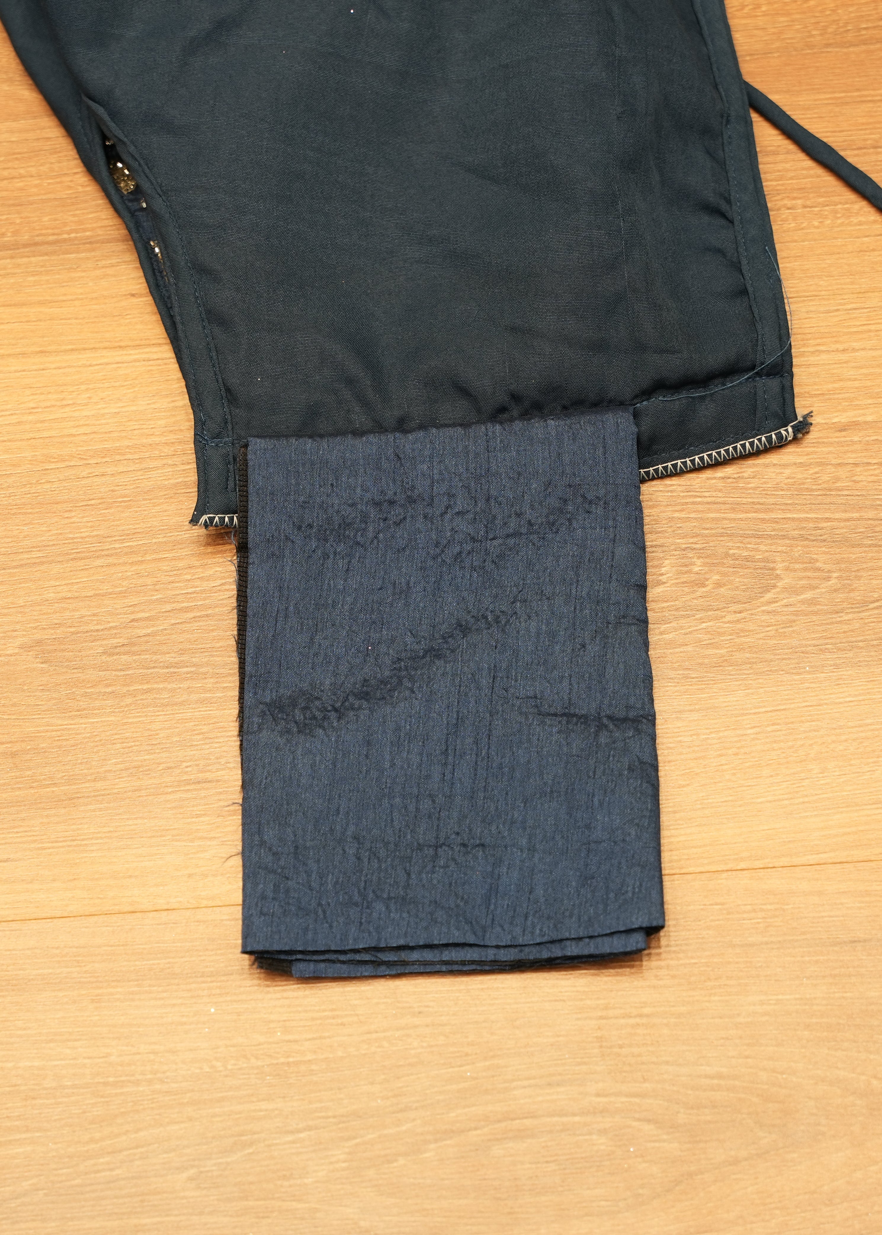 Black jacket with a pocket on a wooden surface