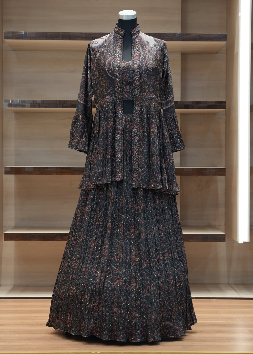 Dark patterned dress on a mannequin against a wooden panel background